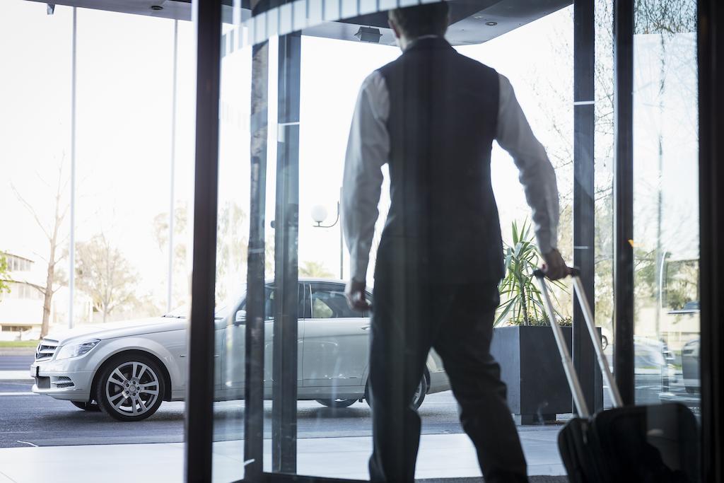 Pullman Melbourne Albert Park Экстерьер фото A doorman opening a revolving door